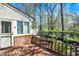 Charming backyard deck with brick accents, complemented by serene landscaping and lush trees at 13587 Kensington Pl, Carmel, IN 46032