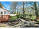 Beautiful backyard with a stone pathway, mature trees, and a charming deck area at 13587 Kensington Pl, Carmel, IN 46032