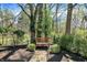 Serene backyard featuring lush greenery, a stone pathway, and a cozy wooden bench at 13587 Kensington Pl, Carmel, IN 46032