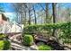 Beautiful backyard oasis featuring a wooden bench, lush greenery, and a stone pathway at 13587 Kensington Pl, Carmel, IN 46032