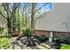 Lush backyard garden featuring mature trees, mulch beds, and brick accents at 13587 Kensington Pl, Carmel, IN 46032