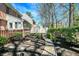 Spacious backyard showcasing lush landscaping, a stone path, and mature trees at 13587 Kensington Pl, Carmel, IN 46032