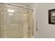 Bathroom shower and tub with glass sliding door and a mounted shower head at 13587 Kensington Pl, Carmel, IN 46032