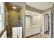 Bathroom with glass enclosed shower, double vanity and neutral color palette at 13587 Kensington Pl, Carmel, IN 46032