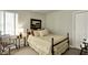 Cozy bedroom with a comfortable bed, side table, and ample natural light at 13587 Kensington Pl, Carmel, IN 46032