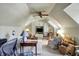Bright bonus room with cozy seating and built-in shelving at 13587 Kensington Pl, Carmel, IN 46032