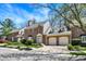 Charming brick townhome featuring attached garages, manicured landscaping, and classic architectural details at 13587 Kensington Pl, Carmel, IN 46032