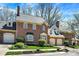 Charming brick townhome featuring attached garages, manicured landscaping, and classic architectural details at 13587 Kensington Pl, Carmel, IN 46032