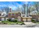Charming brick townhome featuring attached garages, manicured landscaping, and classic architectural details at 13587 Kensington Pl, Carmel, IN 46032