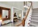 Inviting foyer with hardwood floors, a carpeted staircase, and view to the living room at 13587 Kensington Pl, Carmel, IN 46032