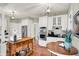 Well-lit kitchen with white cabinetry, stainless steel appliances, and wooden flooring at 13587 Kensington Pl, Carmel, IN 46032