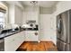 Well-lit kitchen features white cabinets, stainless steel appliances, and dark countertops at 13587 Kensington Pl, Carmel, IN 46032
