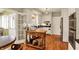 Modern kitchen with stainless steel appliances, wooden floors, and sunroom access at 13587 Kensington Pl, Carmel, IN 46032