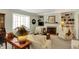 Inviting living room with a fireplace, built-in shelving, and a bay window with lots of natural light at 13587 Kensington Pl, Carmel, IN 46032