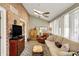 Bright living room with exposed brick, skylights, a ceiling fan, and neutral decor at 13587 Kensington Pl, Carmel, IN 46032