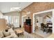 Cozy living room with exposed brick wall and a skylight, providing a bright and inviting atmosphere at 13587 Kensington Pl, Carmel, IN 46032