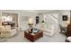 Inviting living room with a classic design, a staircase view, and an open flow to the dining area at 13587 Kensington Pl, Carmel, IN 46032