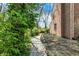 Serene path lined with lush foliage, leading to a charming brick house, inviting exploration of the property at 13587 Kensington Pl, Carmel, IN 46032