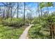 Tranquil gravel path winds through lush greenery, offering a peaceful escape into nature at 13587 Kensington Pl, Carmel, IN 46032