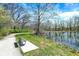 Scenic walking path with bench seating along a tranquil pond, perfect for outdoor enjoyment at 13587 Kensington Pl, Carmel, IN 46032
