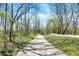 Well-maintained walking path surrounded by trees, ideal for a refreshing outdoor stroll at 13587 Kensington Pl, Carmel, IN 46032