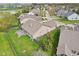 Aerial view displaying the home's backyard with deck, fenced yard, mature trees, and well-kept lawn at 1361 Trescott Dr, Westfield, IN 46074