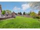 Lush green backyard with a spacious deck and a tall wooden fence at 1361 Trescott Dr, Westfield, IN 46074