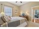 Inviting bedroom with soft tones, plush carpet, and a window with light-filtering blinds at 1361 Trescott Dr, Westfield, IN 46074