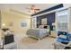 Spacious bedroom featuring a ceiling fan, tray ceilings, neutral carpet, and ample natural light at 1361 Trescott Dr, Westfield, IN 46074