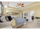 Bright primary bedroom with tray ceilings, ceiling fan, and neutral decor at 1361 Trescott Dr, Westfield, IN 46074