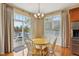 Bright dining area with hardwood floors, backyard access, and stylish lighting fixture at 1361 Trescott Dr, Westfield, IN 46074