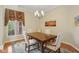 Cozy dining room with natural light, featuring a classic chandelier and neutral decor at 1361 Trescott Dr, Westfield, IN 46074