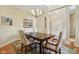 Bright dining room with a modern chandelier, neutral walls, and access to other areas of the home at 1361 Trescott Dr, Westfield, IN 46074
