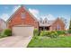 Charming brick home with a manicured lawn, mature landscaping, and a welcoming two-car garage at 1361 Trescott Dr, Westfield, IN 46074