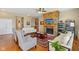 Cozy living room features hardwood floors, a stone fireplace, and a ceiling fan at 1361 Trescott Dr, Westfield, IN 46074