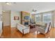 Spacious living room with hardwood floors, a stone fireplace, and large windows for natural light at 1361 Trescott Dr, Westfield, IN 46074