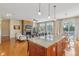 Open concept living area features a kitchen island, fireplace, and backyard access at 1361 Trescott Dr, Westfield, IN 46074