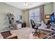 Well-lit home office features a ceiling fan, window, desk, and comfortable office chair at 1361 Trescott Dr, Westfield, IN 46074