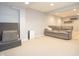Cozy basement featuring a comfortable gray sofa and modern shelving at 13948 Silver Stream Dr, Carmel, IN 46032