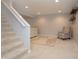 Finished basement area with cozy chair, plush carpet, and decorative shelves at 13948 Silver Stream Dr, Carmel, IN 46032