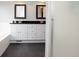 Bathroom featuring a double sink vanity, dark tile floors, and a soaking tub at 13948 Silver Stream Dr, Carmel, IN 46032