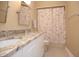 Bathroom featuring a double vanity with granite countertops, floral shower curtain, and modern fixtures for a serene feel at 13948 Silver Stream Dr, Carmel, IN 46032