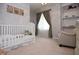 Charming Bedroom with a white crib, plush armchair, soft carpet and stylish curtains, creating a soothing environment at 13948 Silver Stream Dr, Carmel, IN 46032