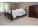 Cozy bedroom featuring a four-poster bed with white linens and a dark wood dresser, creating a relaxing retreat at 13948 Silver Stream Dr, Carmel, IN 46032