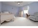 Bright bedroom with light blue walls, a rocking horse, and a comfy armchair creating a peaceful, inviting space at 13948 Silver Stream Dr, Carmel, IN 46032