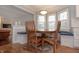 Cozy breakfast nook featuring a round wood table, chairs, and window seating at 13948 Silver Stream Dr, Carmel, IN 46032