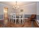Spacious dining room with a long wood table and seating for eight people at 13948 Silver Stream Dr, Carmel, IN 46032