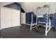 Well-equipped home gym with workout equipment, including a weight rack and bench, set against dark blue walls at 13948 Silver Stream Dr, Carmel, IN 46032