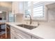 Bright kitchen featuring white cabinets, stainless steel sink, and marble countertops at 13948 Silver Stream Dr, Carmel, IN 46032