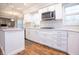 Bright kitchen featuring white cabinets, stainless steel appliances, and a herringbone backsplash at 13948 Silver Stream Dr, Carmel, IN 46032